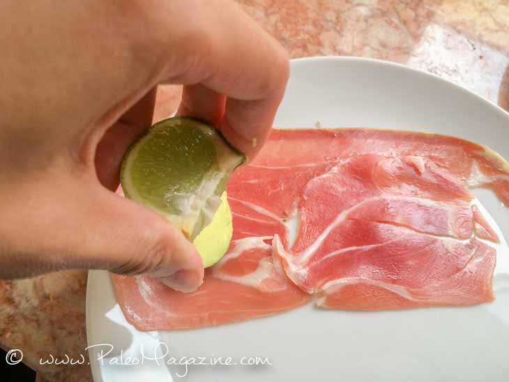 squeeze lime on avocado on prosciutto slice